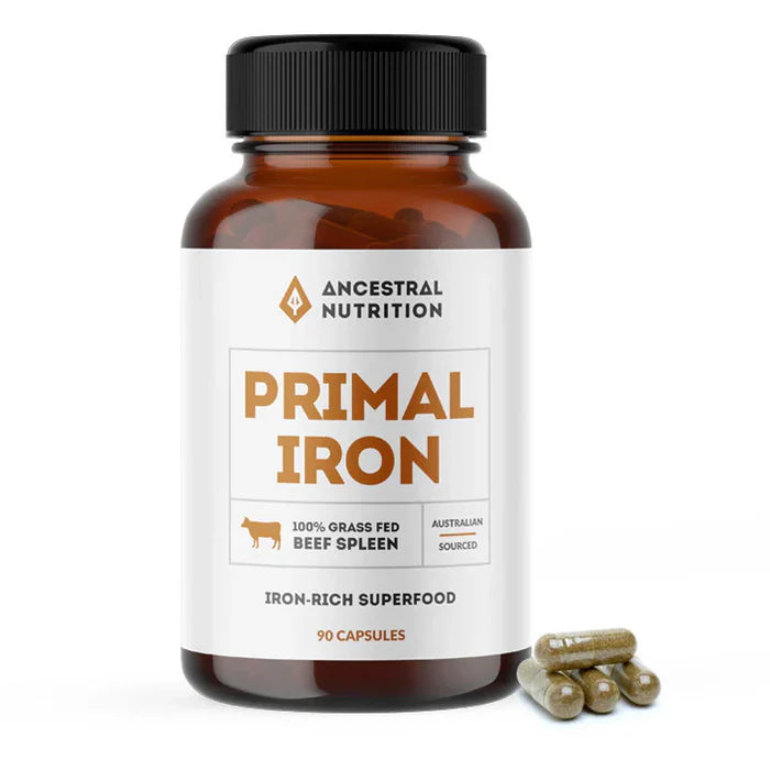 Bottle of Ancestral Nutrition Primal Iron supplement with label visible, showing capsules and product branding.