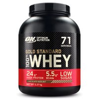 Optimum Nutrition 100% Gold Standard Whey protein powder jar with label and scoop on a white background.