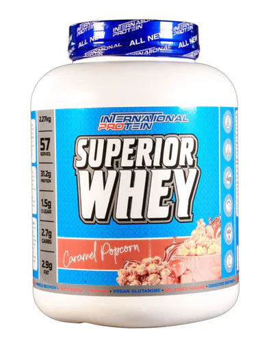 International Protein Superior Whey in caramel popcorn flavor, 2.27kg container with a transparent lid showing the product inside.