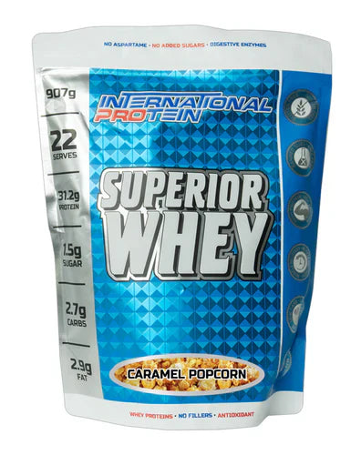 International Protein Superior Whey caramel popcorn protein powder container showing the product label and 907g size.