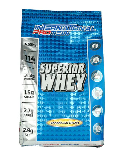 International Protein Superior Whey banana ice cream flavor in 4.55kg container, showing the product packaging and branding.